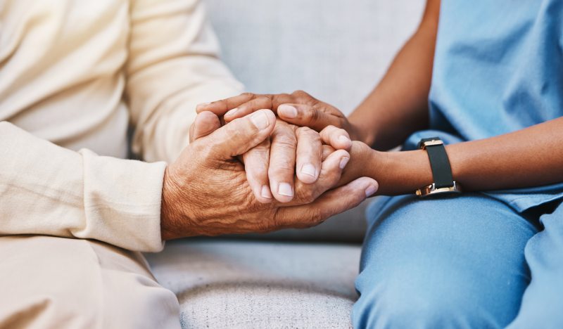 two people holding hands in a comforting manner