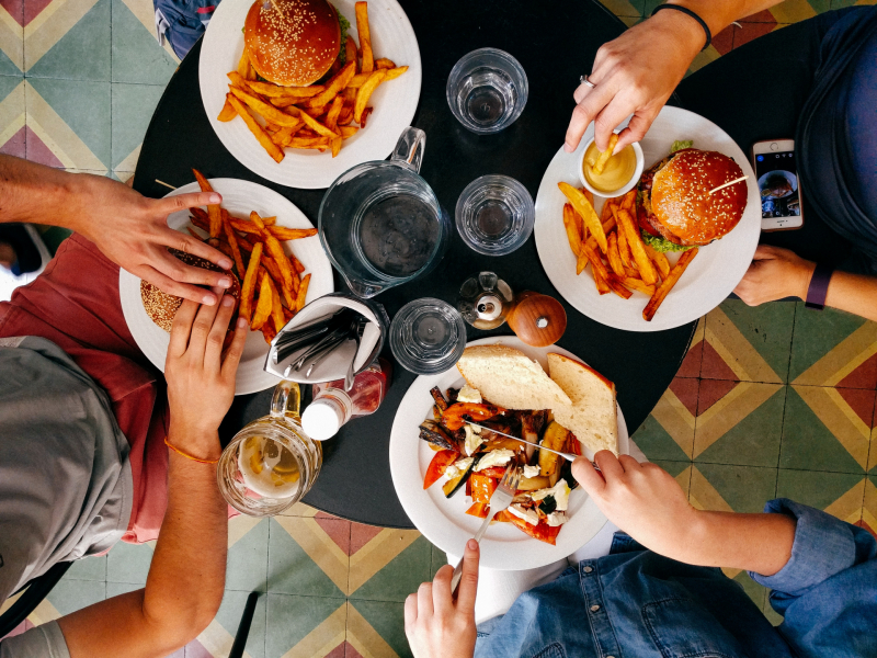 A group of people at a table with food