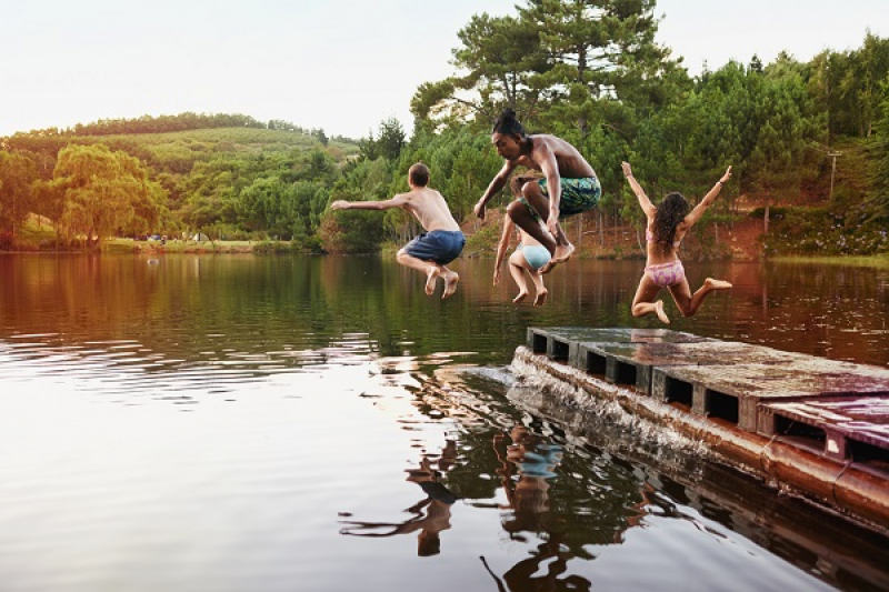 Kids jumping into lake