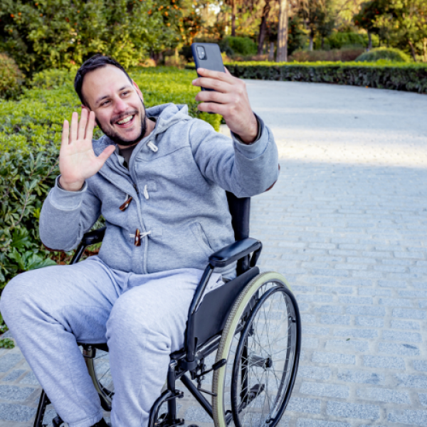 Man in wheelchair taking selfie