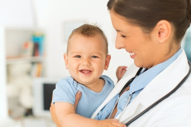 woman physician holding infant