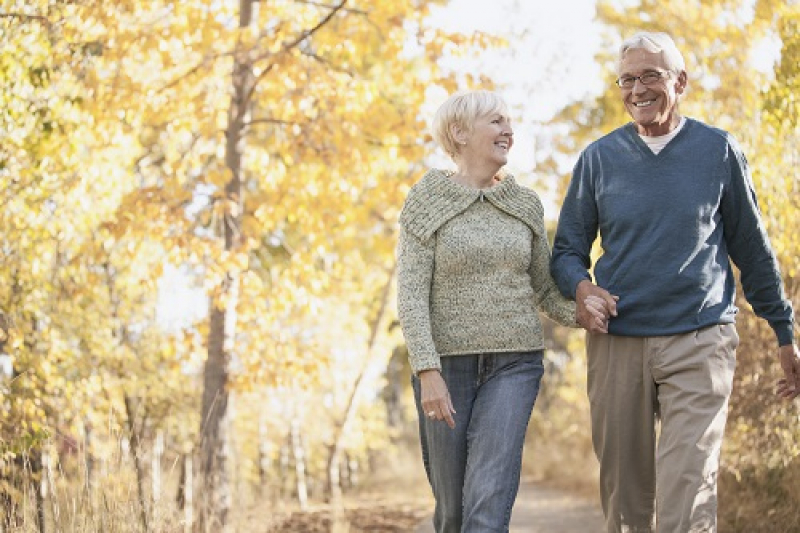 Happy older couple holding hands on a stroll