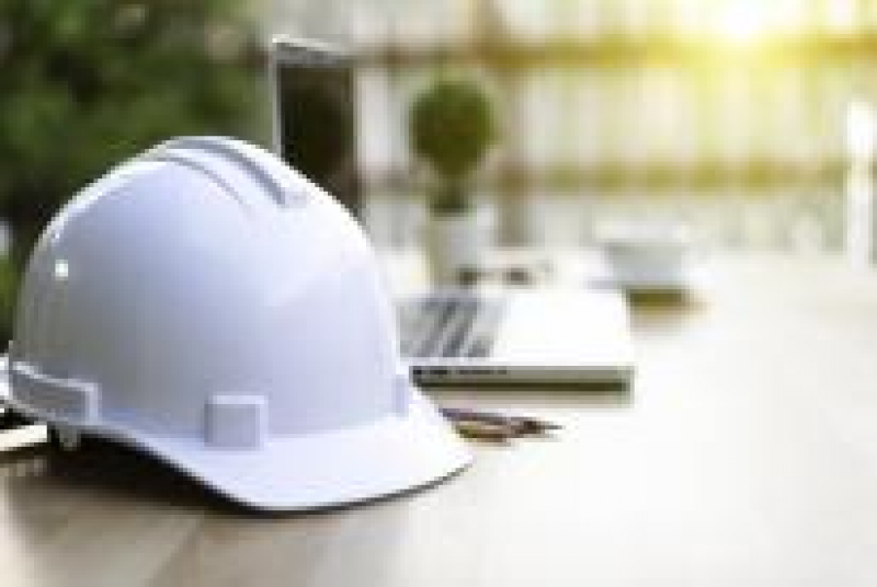White hardhat laying on top of desk