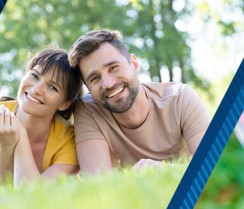 Blue banner with pictures of couple in the grass and a child holding an apple